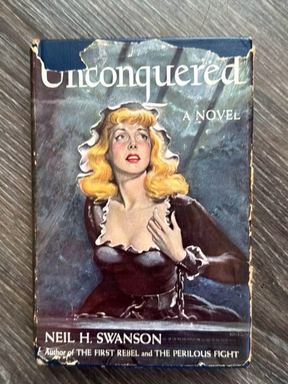 Unconquered by Neil H. Swanson - Vintage Hardcover Book (Blue, Black, Blonde)